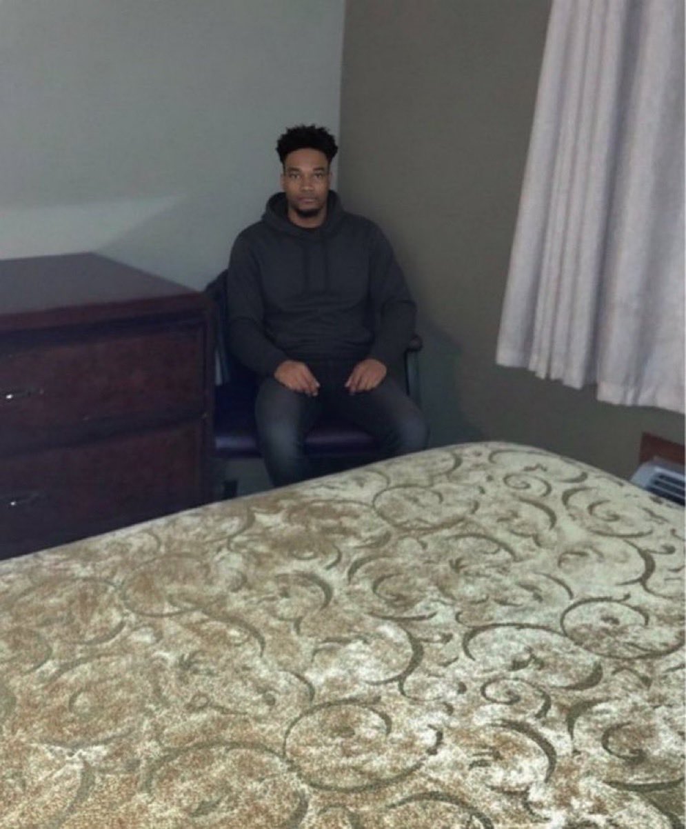 Black Guy In Corner of Motel Room meme template
